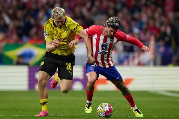 Rodrigo De Paul of Atletico de Madrid battles for the ball with Julian Ryerson of Borussia Dortmund during the UEFA Champions League 2023 24 quarter-finals match between Atletico de Madrid and Borussia Dortmund at Stadium Civitas Metropolitano on April 10, 2024 in Madrid, Spain. FOOTBALL : Atletico Madrid vs Borussia Dormund - UEFA Ligue des Champions - 1 4 Quart - 10 04 2024 LGM Panoramic 