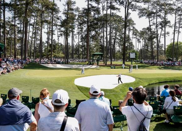 Patrons watch as Hideki Matsuyama of Japan hits from a sand trap by the sixteenth green during the Par 3 Contest at the Masters Tournament at Augusta National Golf Club in Augusta, Georgia on Wednesday, April 10, 2024.  AUG20240410527 TANNENxMAURY
