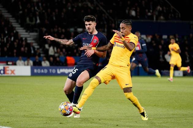 Lucas Beraldo of PSG and Raphinha of Barcelona challenge for the ball Paris Saint-Germain v Barcelona, UEFA Champions League, Quarter Final, First Leg, Football, Parc des Princes, Paris, France - 10 Apr 2024 EDITORIAL USE ONLY No use with unauthorised audio, video, data, fixture lists, club league logos or live services. Online in-match use limited to 120 images, no video emulation. No use in betting, games or single club league player publications. Copyright: xDavexWinter Shutterstockx 14424874il