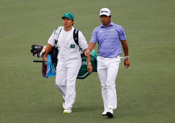Japan s Hideki Matsuyama walks up the second fairway with his caddie Shota Hayajuji during the first round of the Masters Tournament at Augusta National Golf Club in Augusta, Georgia on Thursday, April 11, 2024.  AUG20240411537 TANNENxMAURY