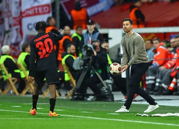Xabi Alonso manager of Beyern Leverkusen passes the ball to Jeremie Frimpong of Beyern Leverkusen Bayer 04 Leverkusen v West Ham United, UEFA Europa League, Quarter Final, First Leg, Football, BayArena, Leverkusen, Germany - 11 Apr 2024 EDITORIAL USE ONLY No use with unauthorised audio, video, data, fixture lists, club league logos or live services. Online in-match use limited to 120 images, no video emulation. No use in betting, games or single club league player publications. Copyright: xMichaelxZemanek Shutterstockx 14424882l