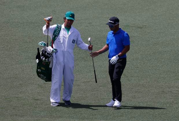 South Korea s Min Woo Lee takes a club from his caddie on the second hole during the first round of the Masters Tournament at Augusta National Golf Club in Augusta, Georgia on Thursday, April 11, 2024.  AUG20240411569 TANNENxMAURY