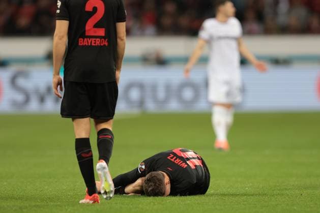 Florian Wirtz Bayer 04 Leverkusen lies on the ground after a foul during the Europa League quarter-final first leg Bayer 04 Leverkusen West Ham United Copyright Thomas Pakusch Copyright: Thomas Pakusch