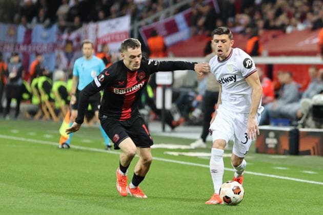 Florian Wirtz Bayer 04 Leverkusen and Aaron Cresswell West Ham United during the Europa League quarter-final first leg Bayer 04 Leverkusen West Ham United Copyright Thomas Pakusch Copyright: Thomas Pakusch