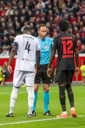 Football UEFA Europa League, 2023 2024 season, quarter-final, first leg, Bayer 04 Leverkusen West Ham United on 11 04 2024 at the BayArena in Leverkusen Referee Arthur Dias in conversation with Kurt Zouma West Ham United, 04 and Edmond Tapsoba Bayer 04 Leverkusen, 12 Photo Kirchner Media TH Copyright: xKirchner-Media THx