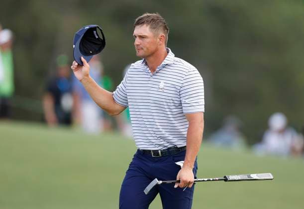 Bryson DeChambeau acknowledges applause as he walks onto the eighteenth hole during the first round of the Masters Tournament at Augusta National Golf Club in Augusta, Georgia on Thursday, April 11, 2024. DeChambeau finished the first round at 7-under-par.  AUG20240411148 JOHNxANGELILLO