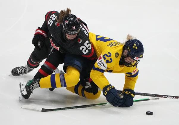 April 11, 2024, Utica, Ny, UNITED STATES: Canada s Jaime Bourbonnais (25) and Sweden s Thea Johansson (23) battle for the puck during third period quarter final hockey action at the IIHF Women s World Hockey Championship in Utica, N.Y., Thursday, April 11, 2024. Canada News - April 11, 2024  - ZUMAc35_ 20240411_zaf_c35_121 Copyright: xChristinnexMuschix