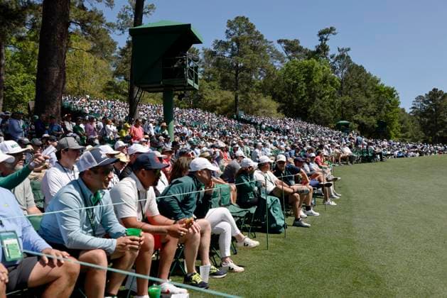 Patrons wait for golfers at Amen Corner near the eleventh hole in the second round of the Masters Tournament at Augusta National Golf Club in Augusta, Georgia on Friday, April 12, 2024.  AUG20240412521 TANNENxMAURY