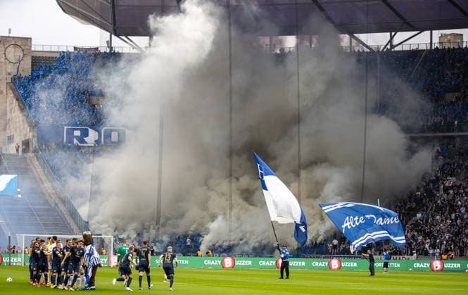 Berlin, 12 04 2024, Soccer, 2 Bundesliga, Matchday 29, Hertha BSC Hansa Rostock, Olympiastadion Fans of Hansa Rostock set Bengal fire in the visitors block of the stadium DFL regulations and DFB regulations prohibit any use of photographs as image sequences and or quasi video, Foto Andreas Gora Hertha BSC Hansa Rostock