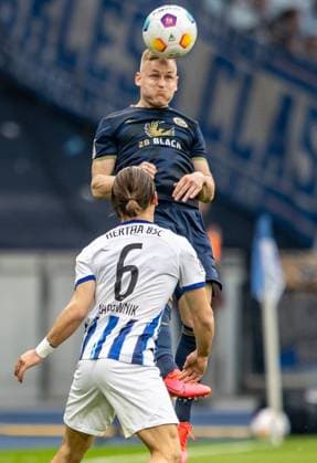 Berlin, 12 04 2024, Soccer, 2 Bundesliga, Matchday 29, Hertha BSC Hansa Rostock, Olympiastadion Kai Proeger of Hansa Rostock jumps for a header against Berlins Michal Karbownik l DFL regulations and DFB regulations prohibit any use of photographs as image sequences and or quasi video, Foto Andreas Gora Hertha BSC Hansa Rostock