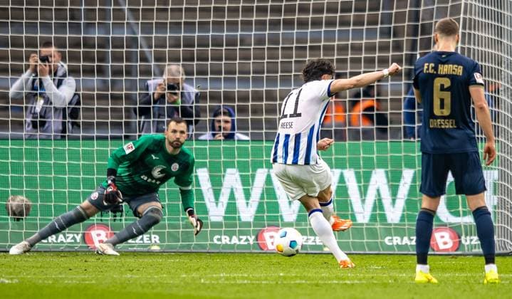 Berlin, 12 04 2024, Soccer, 2 Bundesliga, Matchday 29, Hertha BSC Hansa Rostock, Olympiastadion Berlins Fabian Reese converts penalty kick against goalkeeper Markus Kolke of Hansa Rostock to 2 0 DFL regulations and DFB regulations prohibit any use of photographs as image sequences and or quasi video, Foto Andreas Gora Hertha BSC Hansa Rostock