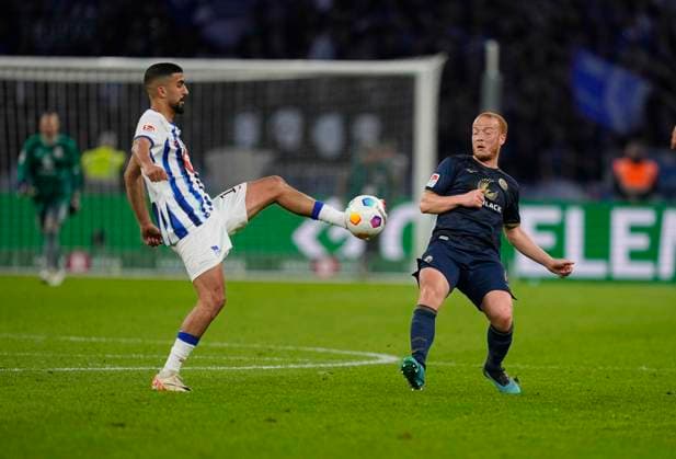 Germany, Berlin, 12 04 2024, Olympic Stadium, Hertha BSC vs FC Hansa Rostock 2 Bundesliga, Andreas Bouchalakis Hertha Berlin and Sebastian Vasiliadis FC Hansa Rostock battle for the ball Berlin Olympic Stadium Berlin Germany eu-images-659