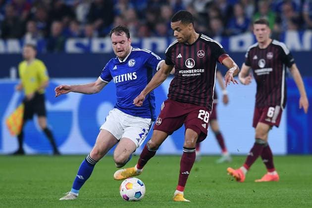 Soccer 2 Bundesliga 29 Matchday FC Schalke 04 1 FC Nürnberg on 13 04 2024 at the Veltins Arena in Gelsenkirchen Thomas Ouwejan Schalke , left Jan Gyamerah Nürnberg , right DFL regulations prohibit any use of photographs as image sequences and or quasi video xRx