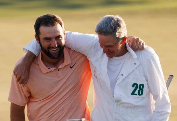 Scottie Scheffler celebrates with caddie Ted Scott after winning the Masters tournament at Augusta National Golf Club in Augusta, Georgia on Sunday, April 14, 2024. Scheffler won with a score of 11 under par.  AUG20240414546 TANNENxMAURY