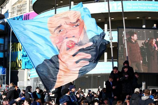 A general view of fans at the Etihad Stadium greeting the team bus with a Manchester City manager Pep Guardiola flag Manchester City v Real Madrid, UEFA Champions League, Quarter Final, Second Leg, Football, Etihad Stadium, Manchester, UK - 17 Apr 2024 EDITORIAL USE ONLY No use with unauthorised audio, video, data, fixture lists, club league logos or live services. Online in-match use limited to 120 images, no video emulation. No use in betting, games or single club league player publications. Copyright: xMattxWest Shutterstockx 14434933b