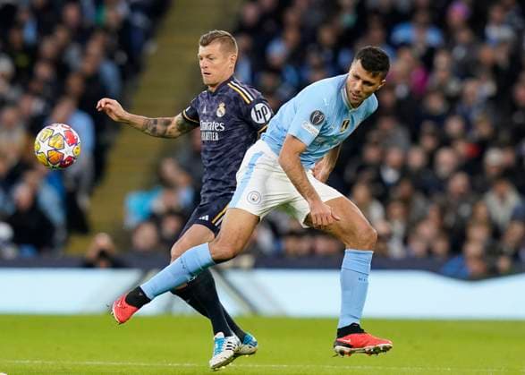 Manchester, England, 17th April 2024. Toni Kroos of Real Madrid tussles with Rodri of Manchester City during the UEFA Champions League Quarter Final 2nd Leg match at the Etihad Stadium, Manchester. Picture credit should read: Andrew Yates Sportimage EDITORIAL USE ONLY. No use with unauthorised audio, video, data, fixture lists, club league logos or live services. Online in-match use limited to 120 images, no video emulation. No use in betting, games or single club league player publications. SPI-3082-0037