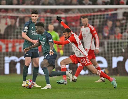 17 04 2024, Football UEFA Champions League 2023 2024 quarter-finals, FC Bayern Munich FC Arsenal London, at Allianz Arena Munich v l Bukayo Saka FC Arsenal v Noussair Mazraoui FC Bayern Munich DFL and DFB regulations prohibit any use of photographs as image sequences and or quasi video