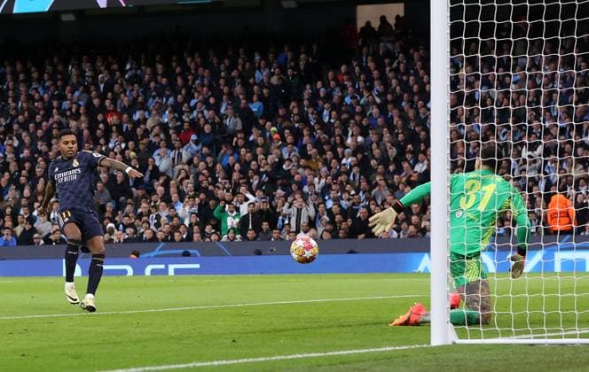 17th April 2024; Etihad Stadium, Manchester, England; Champions League Football, Quarter Final, Manchester City versus Real Madrid; Rodrygo of Real Madrid shoots and scores the opening goal for 0-1 after 12 minutes  ActionPlus12631400 DavidxBlunsden