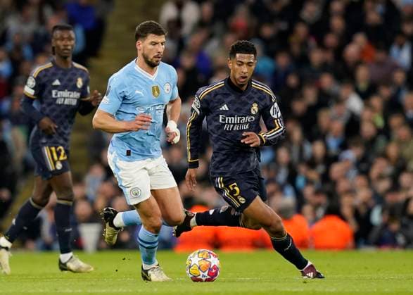 Manchester, England, 17th April 2024. Ruben Dias of Manchester City and Jude Bellingham of Real Madrid during the UEFA Champions League Quarter Final 2nd Leg match at the Etihad Stadium, Manchester. Picture credit should read: Andrew Yates Sportimage EDITORIAL USE ONLY. No use with unauthorised audio, video, data, fixture lists, club league logos or live services. Online in-match use limited to 120 images, no video emulation. No use in betting, games or single club league player publications. SPI-3082-0059