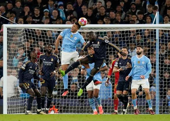 Manchester, England, 17th April 2024. Rodri of Manchester City gets above Ferland Mendy of Real Madrid during the UEFA Champions League Quarter Final 2nd Leg match at the Etihad Stadium, Manchester. Picture credit should read: Andrew Yates Sportimage EDITORIAL USE ONLY. No use with unauthorised audio, video, data, fixture lists, club league logos or live services. Online in-match use limited to 120 images, no video emulation. No use in betting, games or single club league player publications. SPI-3082-0063