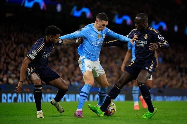 Manchester City v Real Madrid Champions League 17 04 2024. Quarter Final Phil Foden (47) of Manchester City is challenged by Ferland Mendy (23) and Rodrygo Goes (11) of Real Madrid during the Champions League quarter-final second leg match between Manchester City and Real Madrid at the Etihad Stadium, Manchester, England on 17 April 2024. Manchester Etihad Stadium Manchester England Editorial use only , Copyright: xConorxMolloyx PSI-19472-0042