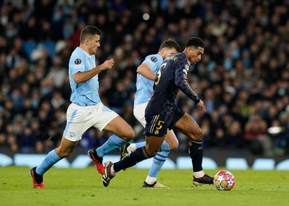Manchester, England, 17th April 2024. Jude Bellingham of Real Madrid moves ahead of Rodri of Manchester City during the UEFA Champions League Quarter Final 2nd Leg match at the Etihad Stadium, Manchester. Picture credit should read: Andrew Yates Sportimage EDITORIAL USE ONLY. No use with unauthorised audio, video, data, fixture lists, club league logos or live services. Online in-match use limited to 120 images, no video emulation. No use in betting, games or single club league player publications. SPI-3082-0067