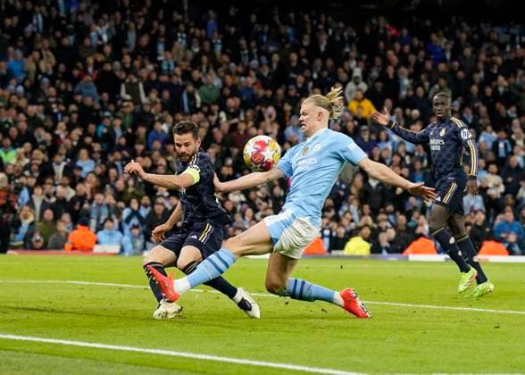 Manchester, England, 17th April 2024. Nacho Fernandez of Real Madrid clears off the line as Erling Haaland of Manchester City closes in during the UEFA Champions League Quarter Final 2nd Leg match at the Etihad Stadium, Manchester. Picture credit should read: Andrew Yates Sportimage EDITORIAL USE ONLY. No use with unauthorised audio, video, data, fixture lists, club league logos or live services. Online in-match use limited to 120 images, no video emulation. No use in betting, games or single club league player publications. SPI-3082-0068