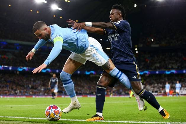 Kyle Walker of Manchester City is challenged by Vinicius Junior of Real Madrid Manchester City v Real Madrid, UEFA Champions League, Quarter Final, Second Leg, Football, Etihad Stadium, Manchester, UK - 17 Apr 2024 EDITORIAL USE ONLY No use with unauthorised audio, video, data, fixture lists, club league logos or live services. Online in-match use limited to 120 images, no video emulation. No use in betting, games or single club league player publications. Copyright: xMattxWest Shutterstockx 14434933bl
