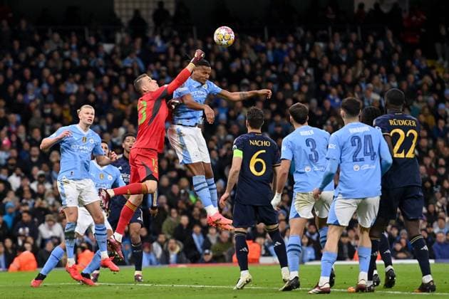 Andriy Lunin of Real Madrid challenges Manuel Akanji of Manchester City during the UEFA Champions League semi final return leg football match between Manchester City and Real Madrid at the Etihad Stadium in Manchester England (Will Palmer SPP) Copyright: xWillxPalmer SPPx spp-en-WiPa-WP6_9143