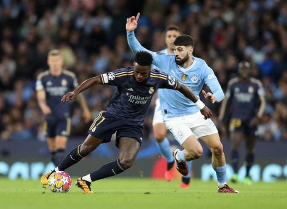 17th April 2024; Etihad Stadium, Manchester, England; Champions League Football, Quarter Final, Manchester City versus Real Madrid; Vinicius Junior of Real Madrid wins the ball from Josko Gvardiol of Manchester City  ActionPlus12631409 DavidxBlunsden