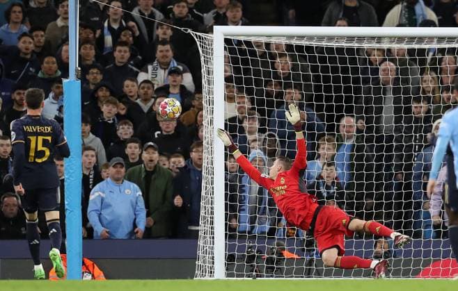 17th April 2024; Etihad Stadium, Manchester, England; Champions League Football, Quarter Final, Manchester City versus Real Madrid; Andriy Lunin of Real Madrid dives to save a shot from Jack Grealish of Manchester City  ActionPlus12631416 DavidxBlunsden