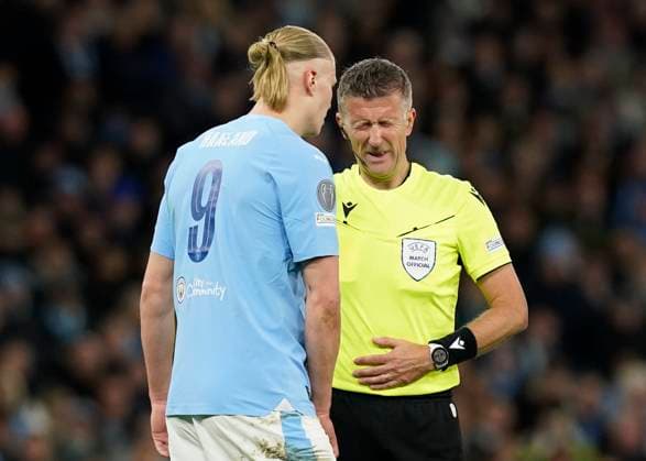 Manchester, England, 17th April 2024. Referee Daniele Orsato grimace after being struck by the ball during the UEFA Champions League Quarter Final 2nd Leg match at the Etihad Stadium, Manchester. Picture credit should read: Andrew Yates Sportimage EDITORIAL USE ONLY. No use with unauthorised audio, video, data, fixture lists, club league logos or live services. Online in-match use limited to 120 images, no video emulation. No use in betting, games or single club league player publications. SPI-3082-0077