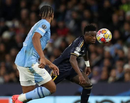 17th April 2024; Etihad Stadium, Manchester, England; Champions League Football, Quarter Final, Manchester City versus Real Madrid; Vinicius Junior of Real Madrid competes with Manuel Akanji of Manchester City for the ball  ActionPlus12631422 DavidxBlunsden