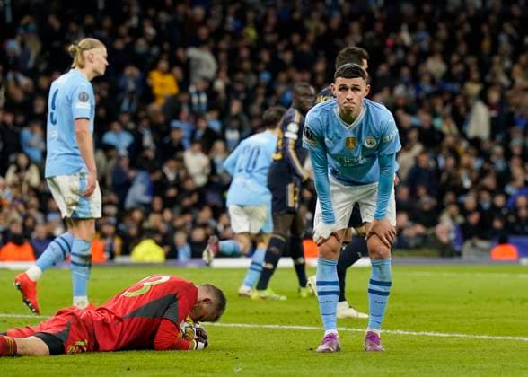 Manchester, England, 17th April 2024. Phil Foden of Manchester City reflects as Andriy Lunin of Real Madrid collectes the ball during the UEFA Champions League Quarter Final 2nd Leg match at the Etihad Stadium, Manchester. Picture credit should read: Andrew Yates Sportimage EDITORIAL USE ONLY. No use with unauthorised audio, video, data, fixture lists, club league logos or live services. Online in-match use limited to 120 images, no video emulation. No use in betting, games or single club league player publications. SPI-3082-0084