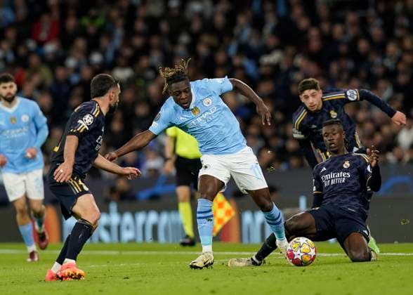 Manchester, England, 17th April 2024. Eduardo Camavinga of Real Madri fouls Jeremy Doku of Manchester City during the UEFA Champions League Quarter Final 2nd Leg match at the Etihad Stadium, Manchester. Picture credit should read: Andrew Yates Sportimage EDITORIAL USE ONLY. No use with unauthorised audio, video, data, fixture lists, club league logos or live services. Online in-match use limited to 120 images, no video emulation. No use in betting, games or single club league player publications. SPI-3082-0097