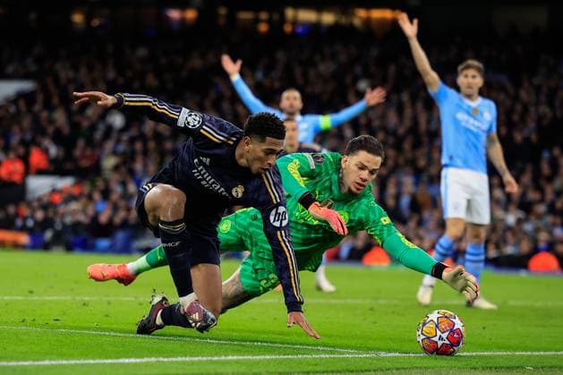 Manchester City v Real Madrid Champions League 17 04 2024. Quarter Final Jude Bellingham (5) of Real Madrid and Ederson (31) of Manchester City challenge for the ball during the Champions League quarter-final second leg match between Manchester City and Real Madrid at the Etihad Stadium, Manchester, England on 17 April 2024. Manchester Etihad Stadium Manchester England Editorial use only , Copyright: xConorxMolloyx PSI-19472-0071