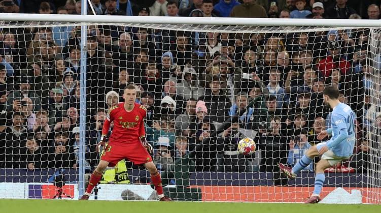 17th April 2024; Etihad Stadium, Manchester, England; Champions League Football, Quarter Final, Manchester City versus Real Madrid; Bernardo Silva of Manchester City sees his penalty kick saved by Andriy Lunin of Real Madrid  ActionPlus12631506 DavidxBlunsden