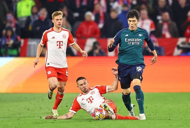 Raphael Guerreiro of Bayern Munich wins the ball from Takehiro Tomiyasu of Arsenal Bayern Munich v Arsenal, UEFA Champions League, Quarter Final, Second Leg, Football, Allianz Arena, Munich, Germany - 17 Apr 2024 EDITORIAL USE ONLY No use with unauthorised audio, video, data, fixture lists, club league logos or live services. Online in-match use limited to 120 images, no video emulation. No use in betting, games or single club league player publications. Copyright: xMichaelxZemanek Shutterstockx 14434936bn