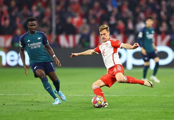 Joshua Kimmich of Bayern Munich and Bukayo Saka of Arsenal Bayern Munich v Arsenal, UEFA Champions League, Quarter Final, Second Leg, Football, Allianz Arena, Munich, Germany - 17 Apr 2024 EDITORIAL USE ONLY No use with unauthorised audio, video, data, fixture lists, club league logos or live services. Online in-match use limited to 120 images, no video emulation. No use in betting, games or single club league player publications. Copyright: xMichaelxZemanek Shutterstockx 14434936br