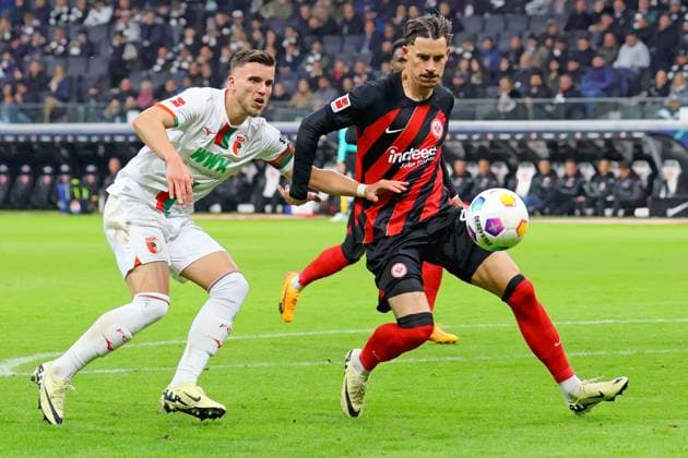 Frankfurt, Germany 19 April 2024 1 BL 2023 2024 Eintracht Frankfurt vs FC Augsburg In the picture from left in a duel Ermedin Demirovic Augsburg vs Robin Koch Frankfurt DFB regulations prohibit any use of photographs as image sequences and or quasi video Deutsche Bank Park Hessen Copyright: xFotostandx xRacochax