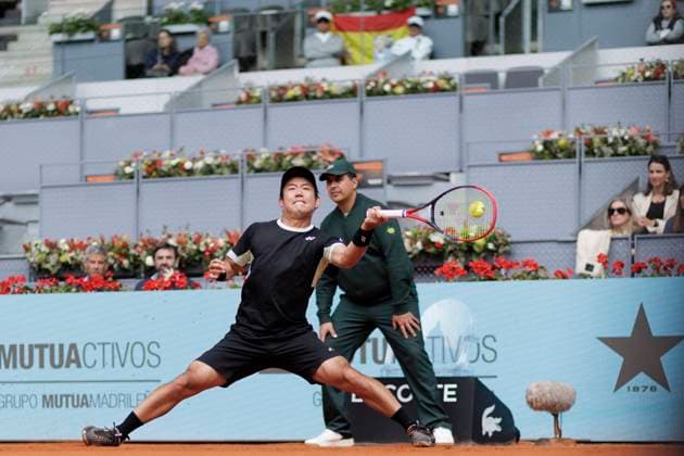 MADRID, SPAIN - APRIL 25: Yoshihito Nishioka returns a shot against Felix Auger during their match on Day 4 of the Mutua Madrid Open at Caja Magica Stadium in Madrid. ONLYxEDITORIALxUSAGE  (251219038)