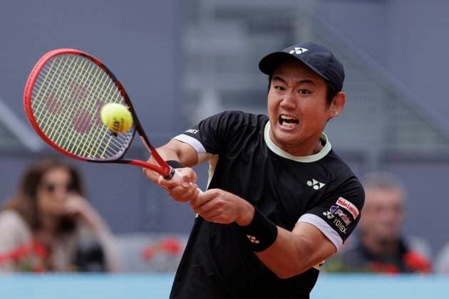 MADRID, SPAIN - APRIL 25: Yoshihito Nishioka returns a shot against Felix Auger during their match on Day 4 of the Mutua Madrid Open at Caja Magica Stadium in Madrid. ONLYxEDITORIALxUSAGE  (251219061)