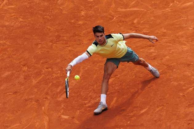 MADRID, SPAIN - APRIL 26:Carlos Alcaraz returns the ball against Alexander Shevchenko during their match on Day 5 of the Mutua Madrid Open at Caja Magica Stadium in Madrid. ONLYxEDITORIALxUSAGE (251341825)