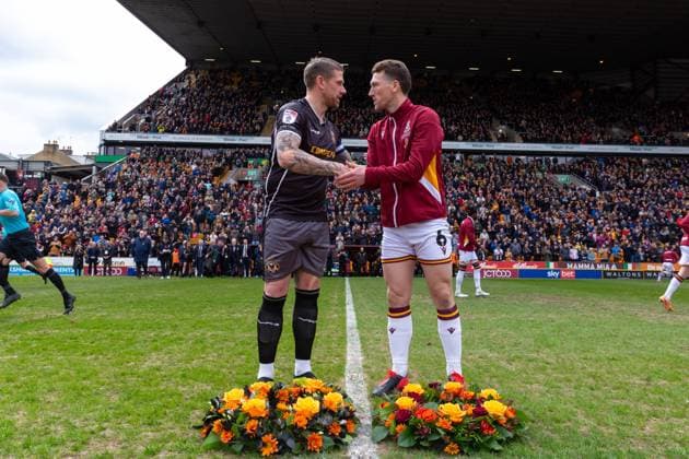Scot Bennett of Newport and Richie Smallwood lay wreaths in memory of the 56 people that lost their lives in the Bradford City fire during the Sky Bet League 2 match between Bradford City and Newport County at the University of Bradford Stadium, Bradford, England on 27 April 2024. Copyright: xThomasxGaddx PMI-6230-0010