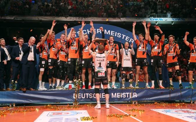 German champion BR Volleys Adam Kowalski with championship trophy in front of the team Joy Emotion Cheering Sport Volleyball Playoff Final 5 Match Bundesliga Men Season 2023 2024 28 04 2024 BR Volleys Berlin BRV vs VfB Friedrichshafen