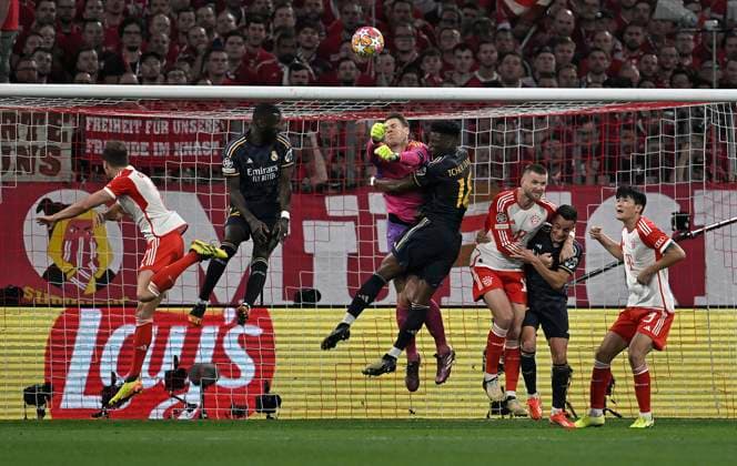 30 04 2024, Football UEFA Championsleague 2023 2024 Semifinal, FC Bayern Munich Real Madrid, at Allianz Arena Munich L R Goalkeeper Manuel Neuer Bayern Munich clears in front of Aurelien Tchouameni Real Madrid DFL and DFB regulations prohibit any use of photographs as image sequences and or quasi video