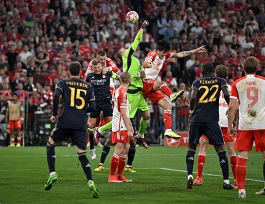 30 04 2024, Football UEFA Championsleague 2023 2024 Semifinal, FC Bayern Munich Real Madrid, at Allianz Arena Munich L R Goalkeeper Andriy Lunin Real Madrid can clear for Minjae Kim Bayern Munich DFL and DFB regulations prohibit any use of photographs as image sequences and or quasi video
