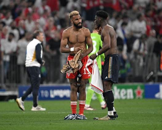 30 04 2024, Football UEFA Champions League 2023 2024 semi-final, FC Bayern Munich Real Madrid, at Allianz Arena Munich L R Eric Maxim Choupo Moting Bayern Munich and Aurelien Tchouameni Real Madrid swap jerseys DFL and DFB regulations prohibit any use of photographs as image sequences and or quasi video