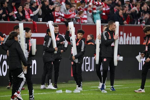 The ball boys collect the beer cups after the game 03 05 2024, Soccer 2 Bundesliga, Matchday 32, Season 2023 2024 Fortuna Düsseldorf 1 FC Nürnberg Düsseldorf North Rhine-Westphalia Germany Team2