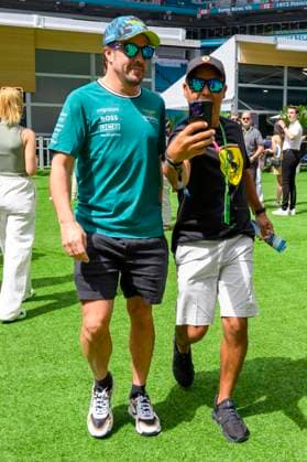 4th May 2024; Miami International Autodrome, Miami, Florida, USA; Formula 1 Crypto.com Miami Grand Prix 2024; Qualifying Day; Aston Martin Aramco driver Fernando Alonso of Spain takes a selfie with a fan in the Team Village.  ActionPlus12638055 DouglasxMurray